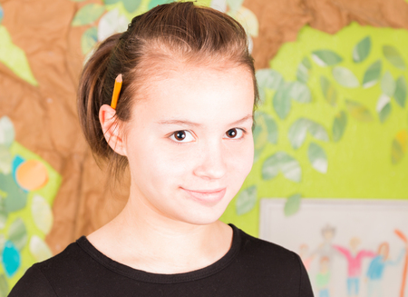 Beautiful Young Girl With Pencil on Earの写真素材