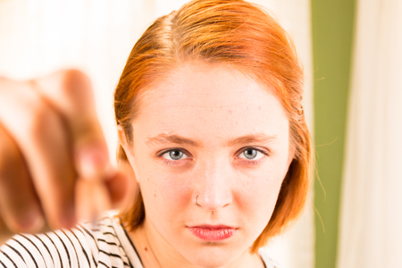 Closeup Blur of Hand and Pencil in Foreground With Readhead Girl in Backgroundの写真素材