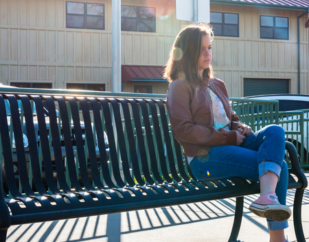 Cute Young Girl Sitting Near Train Railsの写真素材