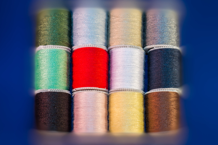 Many Color Cotton Reel Spools of Sewing Thread With Blurred Border