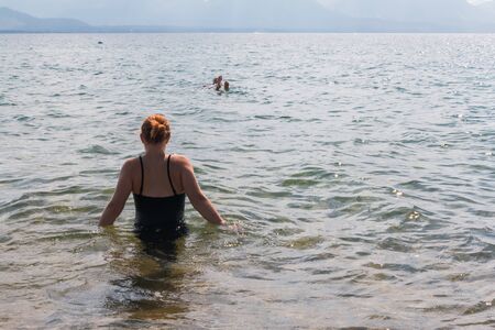 Beautiful Young Girl With Raised Arms in the  Water at the Beachの写真素材