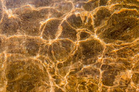 Bright Reflections of Water Ripples on Lake Bottomの写真素材