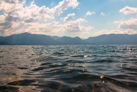 Waves of Water and Splashes on the Lake Shoreline