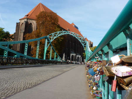 Tumski bridge and Church of Our Lady on Sand in Wroclaw. Poland. Padlock on the bridge.の写真素材