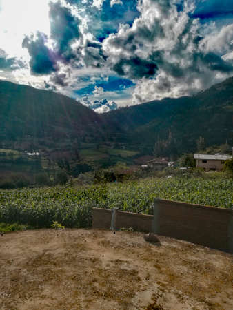 incredible scenery with mountains and beautiful white clouds in the sun's glare