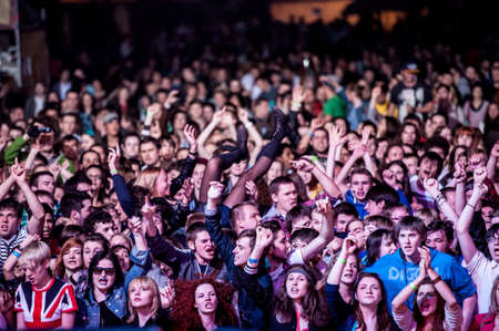 Crowd surfing during rock show.