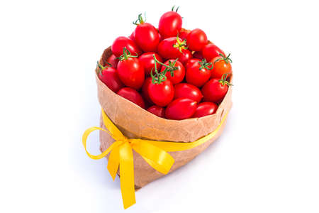 Tomatoes in paper bag isolated on whiteの写真素材