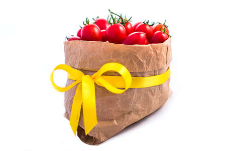 Tomatoes in paper bag isolated on whiteの写真素材