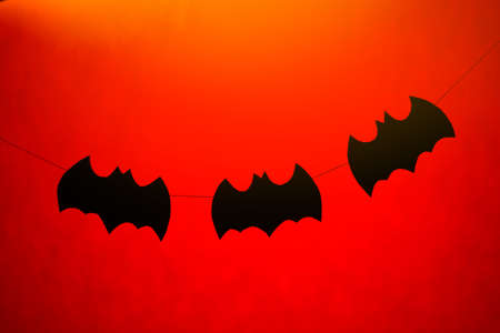 Halloween paper garlands on orange backgroundの写真素材