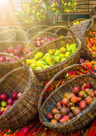 Apples, pears and persimmons in basketsの写真素材