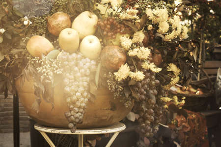 Bowl with autumn fruits and flowers in vintage style