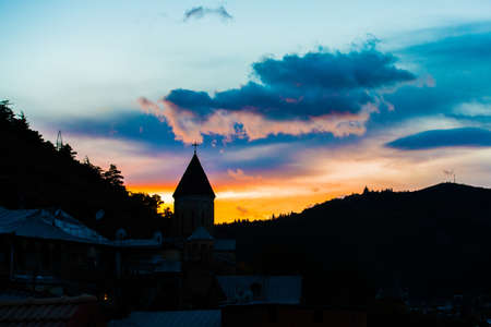 Silhouette of church and mountain in sunset