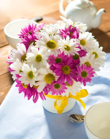 Bouquet of pink and white chrysanths on wooden backgroundの写真素材