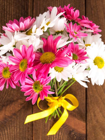 Bouquet of pink and white chrysanths on wooden backgroundの写真素材
