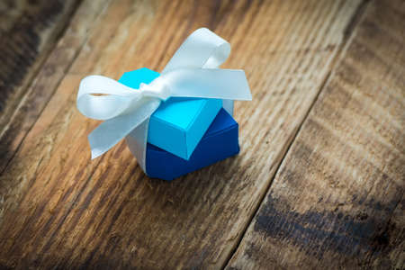 Two paper hearts with white ribbon on wooden backgroundの写真素材