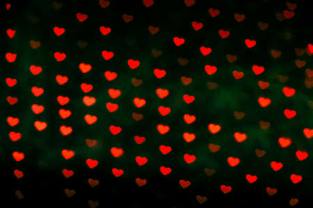 Heart bokeh on a dark backgroundの写真素材