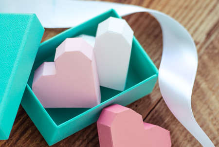 Bright paper hearts in gift box on wooden backgroundの写真素材