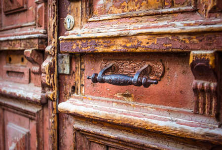 Wooden door with iron handle and mailbox holeの写真素材