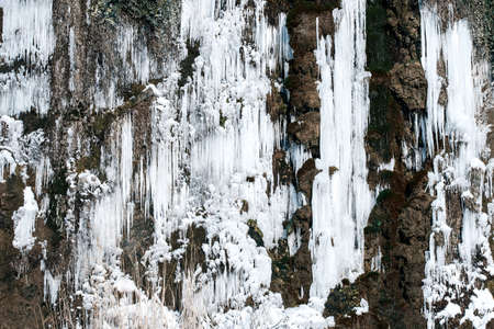 Icicles on frozen waterfallの写真素材