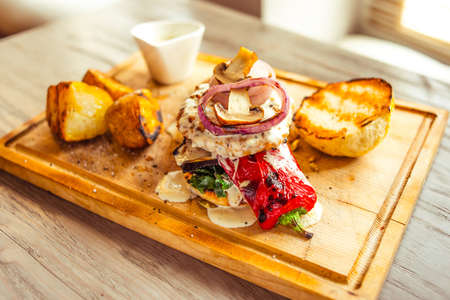 Originally served beef burger with vegetables in restaurantの写真素材