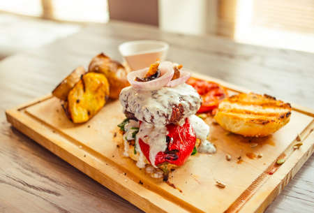 Originally served beef burger with vegetables in restaurantの写真素材