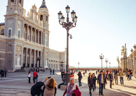 MADRID, SPAIN - MARCH 12: Unidentified people walk over the square near Almudena Cathedral in March 12, 2014 in Madrid, Spain. Santa Maria la Real de La Almudena is a neogothic cathedral.のeditorial素材