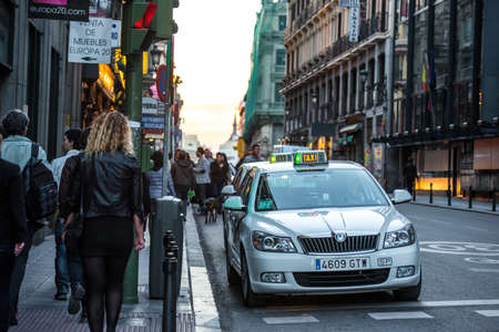 MADRID, SPAIN - MARCH 12: Old narrow street with taxi cabs in March 12, 2014 in Madrid, Spain. It is...