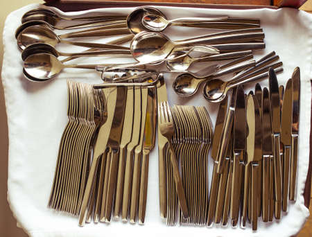 Closeup of arranged spoon, knife and fork. Picture toned in vintage styleの写真素材