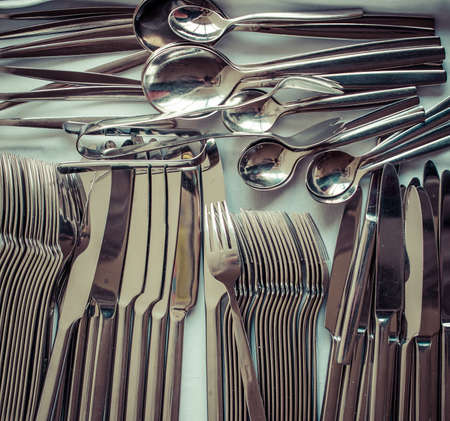 Closeup of arranged spoon, knife and fork. Picture toned in vintage styleの写真素材