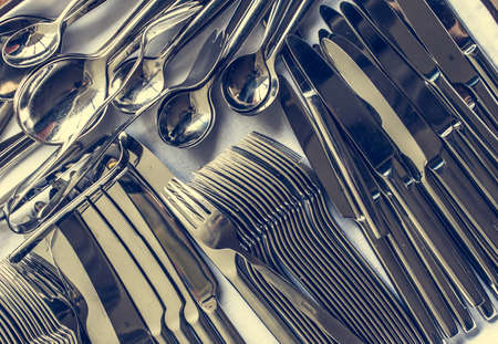 Closeup of arranged spoon, knife and fork. Picture toned in vintage styleの写真素材