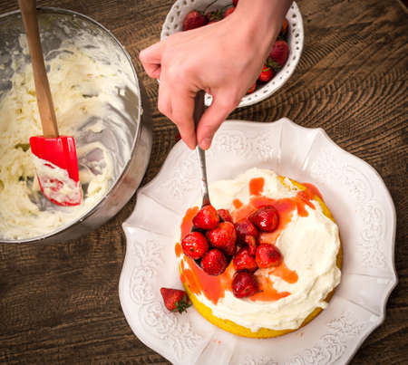 Preparation of the strawberry cake with whipped creamの写真素材