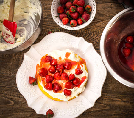 Preparation of the strawberry cake with whipped creamの写真素材