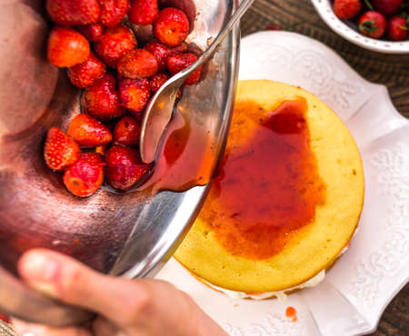 Preparation of the strawberry cake with whipped creamの写真素材