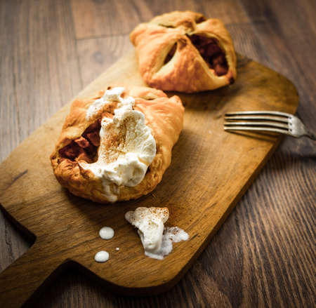 Delicious homemade apple strudel with icecream on wooden backgroundの写真素材