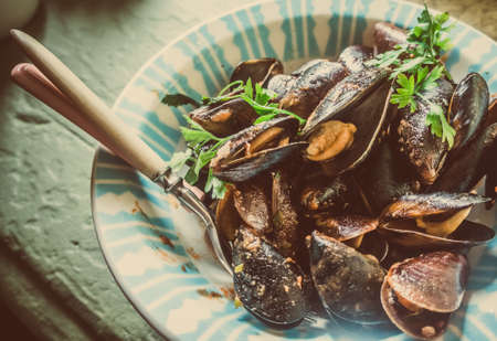 Mussels in tomato sauce on plate. Toned pictureの写真素材