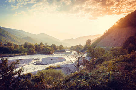 Mountain and Rioni river sunset view in summer in Racha region, Georgia, Caucasus. Toned pictureの写真素材
