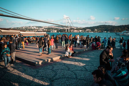 ISTANBUL, TURKEY - : october 23, 2014: people are walking on a quay admiring Bophorus bridge in front of the mosque on Ortakoy square, istanbul, Turkey.のeditorial素材