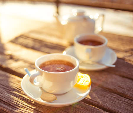 Cups of tea on a wooden table. Toned pictureの写真素材