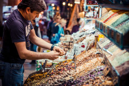 ISTANBUL, TURKEY -  october 26, 2014: Vendor is selling spices and tea at Spice market in Istanbul, Turkey.のeditorial素材