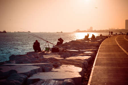 ISTANBUL, TURKEY, October, 26, 2014: People are fishing on Marmara sea quay in Bakirkoy in Istanbul, Turkey.のeditorial素材