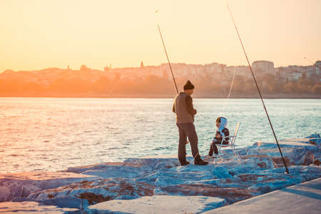 ISTANBUL, TURKEY, October, 26, 2014: Man is fishing with his son on Marmara sea quay in Bakirkoy in Istanbul, Turkey.のeditorial素材