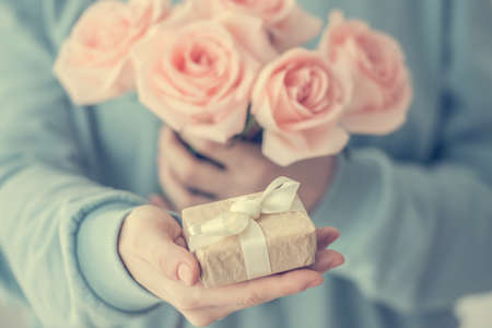 Hands holding bouquet of beautiful pink roses. Toned pictureの写真素材