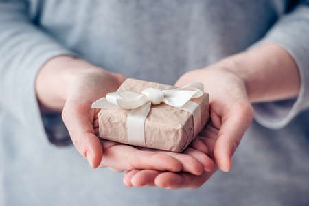 Hands holding small paper gift boxの写真素材