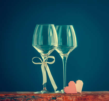Two wine glasses om blue background. Toned pictureの写真素材