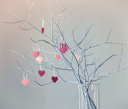 Beautiful decorative white branches with small valentine's hearts. Toned pictureの写真素材