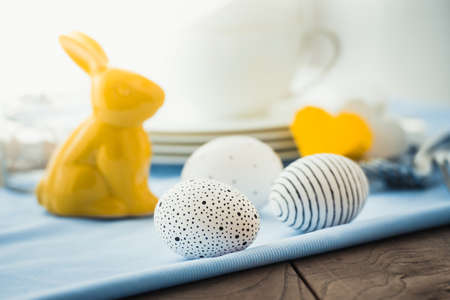 Modern painted easter eggs on wooden table
