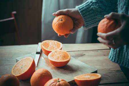 Fresh oranges on wooden table. Toned pictureの写真素材