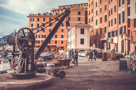 CAMOGLI, ITALY - FEBRUARY 27, 2015: A view of the marina of the fisherman village of Camogli, with local fishing boats and the characteristic pastel-colored houses. Toned pictureのeditorial素材
