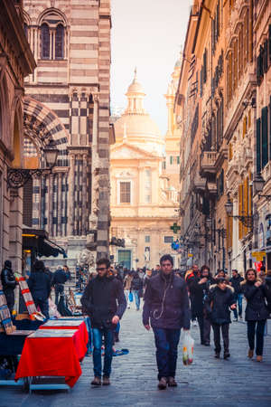 GENOA, ITALY - FEBRUARY 27, 2015: Tourists and locals walk near Cathedral of Saint Lawrence at the old city centre of Genoa, Italyのeditorial素材