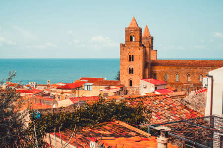 View on old red roofs and famous medieval cathedral in Cefalu city. SIcily island, Italyの写真素材